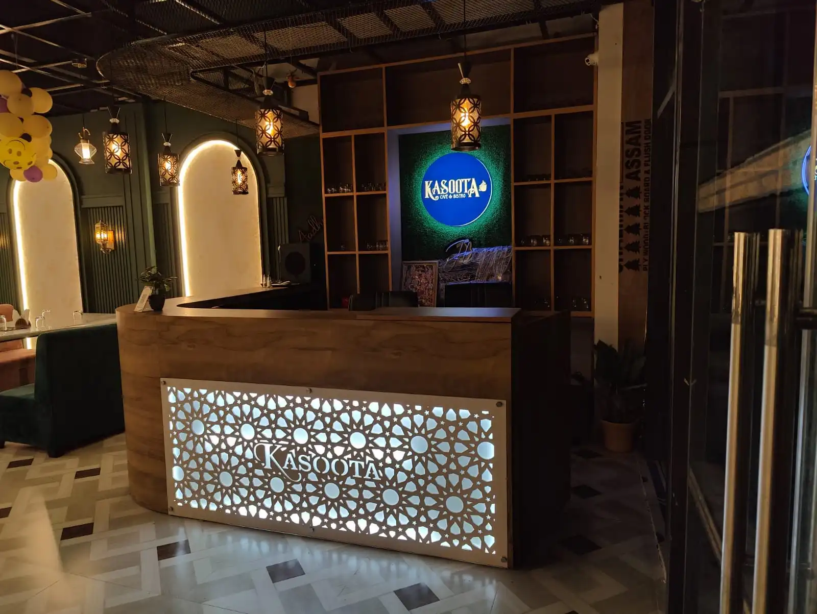 Kasoota Café & Bistro's host counter and jaali-lattice signage, Ayodhya